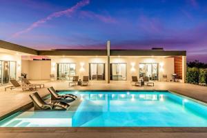 a swimming pool in the middle of a house at Romantic Escape, Walk to Beach, Pool, Hammock in Long Bay Hills