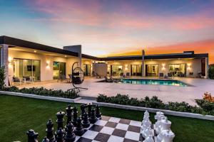 a house with a chess board in the yard at Romantic Escape, Walk to Beach, Pool, Hammock in Long Bay Hills