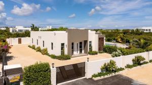an aerial view of a white house at Romantic Escape, Walk to Beach, Pool, Hammock in Long Bay Hills