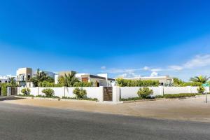 a white fence in front of a house at Romantic Escape, Walk to Beach, Pool, Hammock in Long Bay Hills