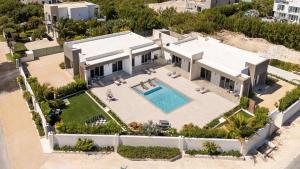 an aerial view of a house with a swimming pool at Romantic Escape, Walk to Beach, Pool, Hammock in Long Bay Hills