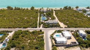 an aerial view of a resort with the ocean at Romantic Escape, Walk to Beach, Pool, Hammock in Long Bay Hills