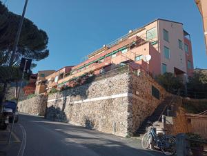 a building on top of a stone wall with a bike at La Conchiglia di Monterosso in Monterosso al Mare