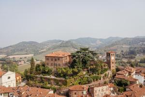 a view of a town with mountains in the background at Castello di Casalborgone, Luxury Italian Castle Hotel in Casalborgone