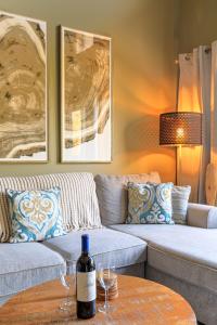 a living room with a couch and a bottle of wine on a table at Summit at The Lodges of Canmore in Canmore +42 photos