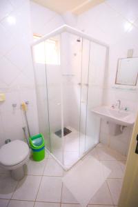 a bathroom with a shower and a toilet and a sink at Premier Palace Hotel in Araranguá +19 photos