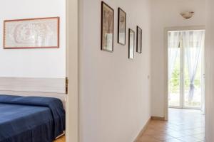 a bedroom with a bed and pictures on the wall at Villa La Pineta in Plemmirio +37 photos