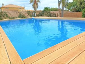 a large swimming pool with blue water at Villa La Pineta in Plemmirio