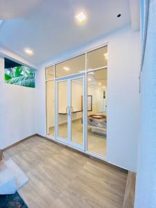 a room with sliding glass doors and a bedroom at Vega Haven in Matara