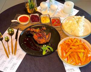 a table with a plate of food and french fries at OTAKU Restaurant in Johannesburg +12 photos