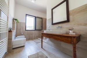 a bathroom with a sink and a tub and a mirror at Villa del Sole in Plemmirio +24 photos