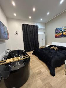a bedroom with a large black bed and a bath tub at Sweet dreams in Palermo