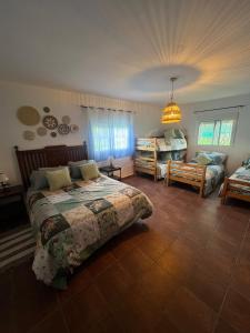a bedroom with a bed and a couch at Villa Antaquira in Antequera