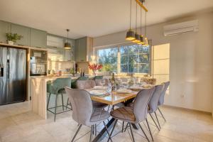 a kitchen with a wooden table and chairs in a kitchen at Villa Florina Ninski Stanovi in Ninski Stanovi