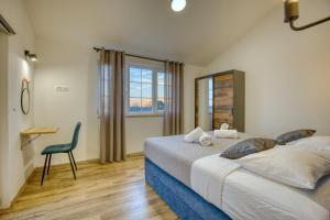 a bedroom with a bed and a chair and a window at Villa Florina Ninski Stanovi in Ninski Stanovi +38 photos