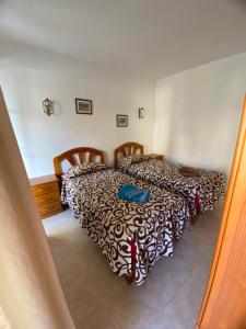 a bedroom with two beds in a room at Atardecer Azul in Puerto Naos +11 photos