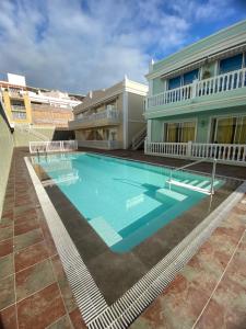 a large swimming pool in front of a building at Atardecer Azul in Puerto Naos