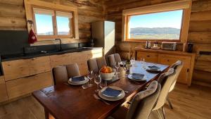 a dining room with a table and chairs in a cabin at Chalet l'éléphant in Foncine-le-Haut