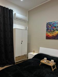 a bedroom with a bed and a cabinet and a painting at Sweet dreams in Palermo
