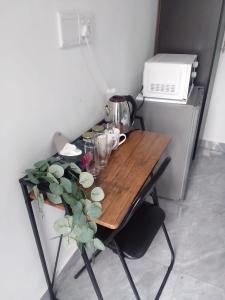 a wooden table with a plant on top of it at 60 On Kosmos in Bellville South