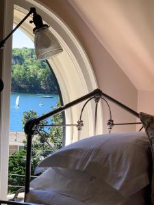 a bedroom with a bed with a view of the water at The Pebble Bed and Breakfast in Halifax