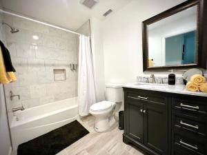 a bathroom with a tub and a toilet and a sink at Gorgeous Home, Great Vibes & Nonstop Fun! in Desert Hot Springs +7 photos