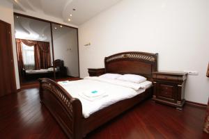 a bedroom with a bed and a dresser and a mirror at Real Home Apartments in Kiev Center in Kyiv +184 photos