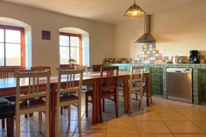a kitchen with a large wooden table and chairs at Agroturystyka Dom pod Sową in Nawojów Łużycki