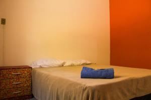 un letto con una borsa blu seduta sopra di esso di Casinha Aconchegante a Ouro Preto