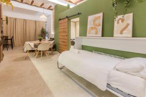 a bedroom with a bed and a dining room at GREEN&FRESH Apartament in Valencia