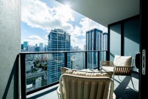 a balcony with two chairs and a view of the city at NEW Suite Downtown Miami - Amazing view 27th floor in Miami