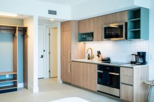 a kitchen with wooden cabinets and a counter top at NEW Suite Downtown Miami - Amazing view 27th floor in Miami