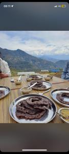 a table with plates of food on top of it at Panchase Family Homestay in Pokhara