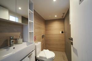 a bathroom with a white toilet and a sink at LUX ONE The Ioannina Residence in Ioannina +12 photos