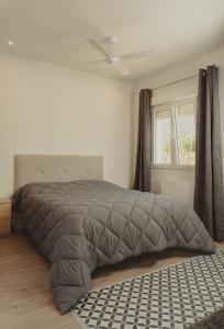 a bed in a white room with a window at Bellevall resort, hotel y apartamentos in Aspe