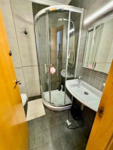 a bathroom with a shower and a sink at Olivia in Barrio-Mar