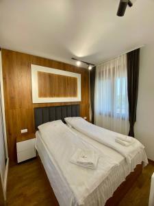 a large white bed in a room with a window at Magnet 12 in Zlatibor +15 photos