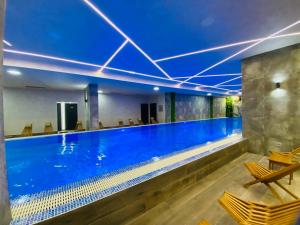 a large swimming pool with a blue ceiling at Magnet 12 in Zlatibor