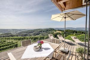 a patio with a table and chairs and a view at Winzarei Ciringa Stampfer in Svečina