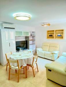 a living room with a table and a couch at Olivia in Barrio-Mar