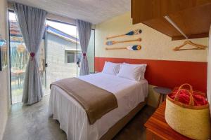 a bedroom with a bed and a large window at Paraíso Patacho Riviera Casa 01 Villa 04 in Pôrto de Pedras +65 photos