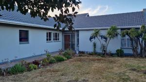 a white house with a yard in front of it at Silva Dolphin in Vredenburg