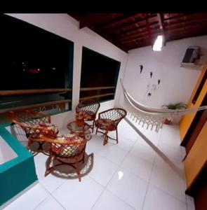 a balcony of a house with chairs and a tub at Casa de Praia na rota de Milagres - Praia de Marceneiro in Passo de Camarajibe