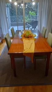 a wooden dining table with a yellow napkin on it at InspireBA - Terrace in Buenos Aires