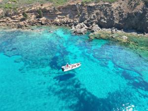 a group of people in a boat in the ocean at Acquamaris Tuerredda in Teulada