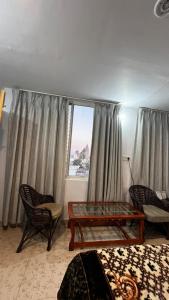 a living room with a table and chairs and a window at MistyBlue - The Penthouse Best Sunrise View Room in Orchha +61 photos