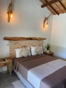 a bedroom with a bed and a brick wall at Acquamaris Tuerredda in Teulada