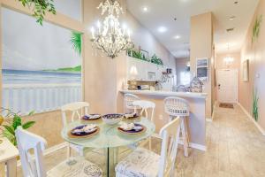 a dining room and kitchen with a table and chairs at Community Pool Coastal Escape in Flagler Beach in Flagler Beach