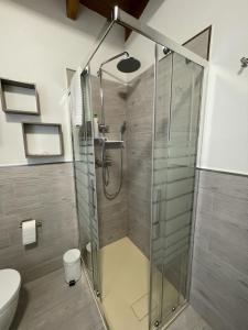 a shower with a glass door in a bathroom at Una Casetta InterVineas in Spoleto +7 photos