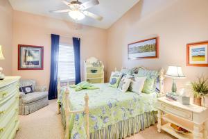 a bedroom with a bed and a chair and a ceiling fan at Community Pool Coastal Escape in Flagler Beach in Flagler Beach +23 photos